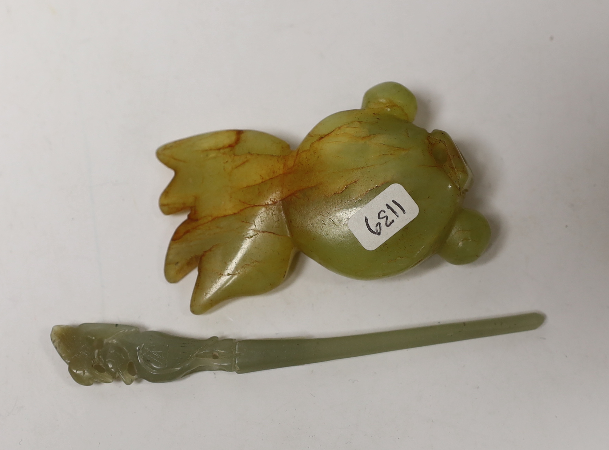 A Chinese greenish-yellow and russet jade goldfish and a pale celadon jade hairpin, 11cm in length